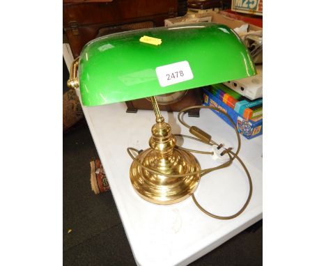A desk lamp, on brass support, with green domed shade. 