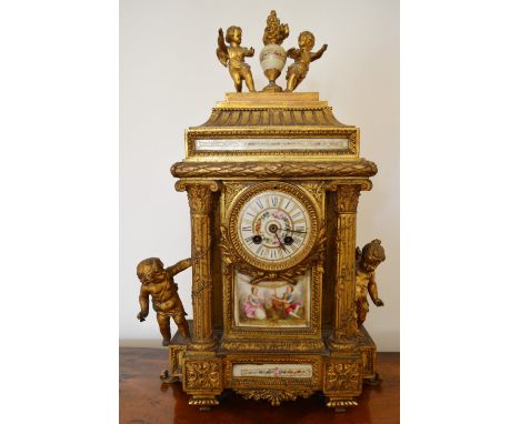 A French Gilt Metal Large Mantle Clock, the porcelain panels hand painted with figures, the dial with Roman numerals and two 