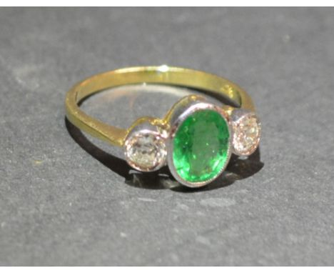 An 18ct. Yellow Gold Emerald and Diamond Ring, with a central oval emerald flanked by diamonds within a pierced setting