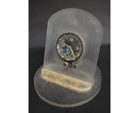 A WWII German Messerschmitt Cockpit Clock mounted on a perspex stand