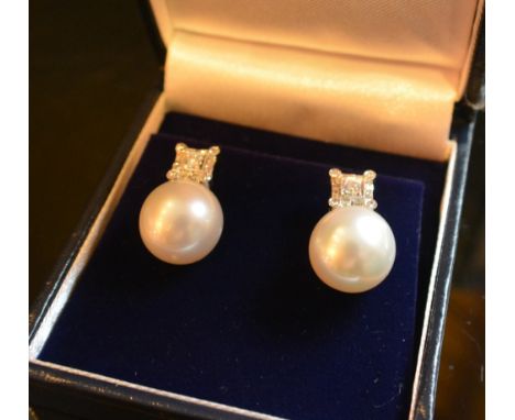 A Pair of 18ct. White Gold Diamond and South Sea Pearl Drop Ear Studs, approximately 0.48 ct.