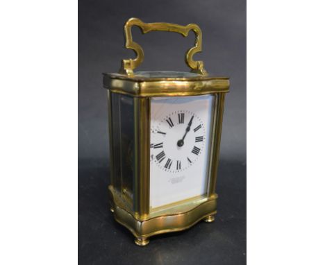A 19th Century French Brass Cased Carriage Clock, the serpentine case with carrying handle and lever escapement