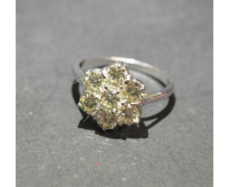 An 18ct. White Gold Diamond Cluster Ring, set with seven diamonds within a pierced setting, approximately 1.50 ct.