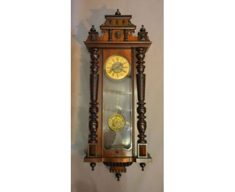 A Victorian Mahogany Vienna Wall Clock with Ring Turned Columns, the enamel and brass dial with two train striking movement
