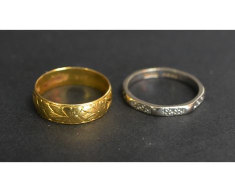 A 22ct. Gold Wedding Band, 3.4 gms., together with an 18ct. white gold band ring, 3.2 gms.