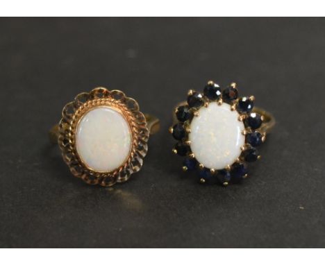 A 9ct. Gold Opal and Garnet Set Cluster Ring, together with another similar 9ct. gold opal set ring