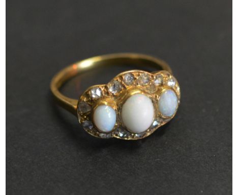 An 18ct. Gold Opal and Diamond Ring with three cabochon opals surrounded by diamonds within a shaped setting