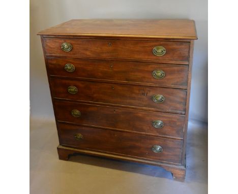 A George III Mahogany Chest in two parts, the moulded top above five graduated drawers with oval brass handles raised upon br