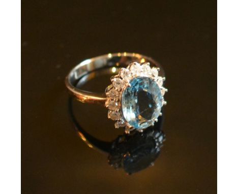 A White Gold Oval Aquamarine and Diamond Cluster Ring, approximately 1.86 / 0.38 ct. 