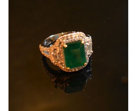 An 18ct. White Gold Emerald and Diamond Ring, approximately 3.10 / 0.77 ct.