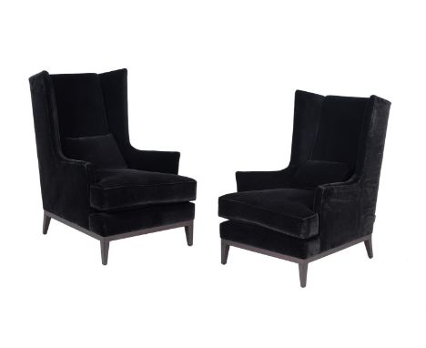 A PAIR OF BLACK VELVET UPHOLSTERED ARMCHAIRSRECENTLY MANUFACTURED BY THE SOFA AND CHAIR COMPANY, LONDONWith manufacturer's ti