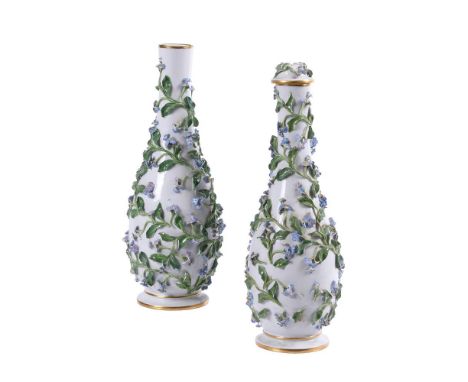 A PAIR OF MEISSEN FLOWER-ENCRUSTED SLENDER BOTTLE VASES AND A COVERLATE 19TH CENTURYBlue crossed swords and impressed marks30