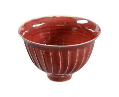 λ  DAVID LEACH (1911-2005), A RED GLAZED STUDIO POTTERY FOOTED BOWLOf cut-sided formImpressed DL mark13.5cm diameterCondition