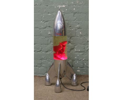 A vintage retro chrome lava lamp by Mathmos formed as a rocket.
