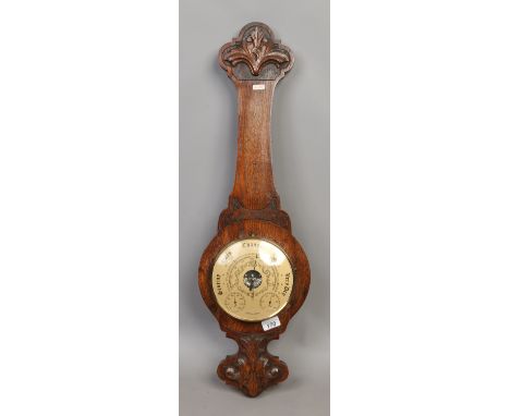 A carved oak cased banjo barometer.