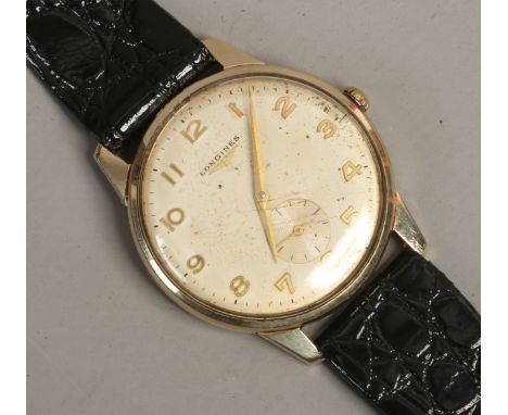 A gentlemans vintage 9ct gold Longines manual wristwatch with applied gold Arabic numeral markers, pointed baton hands and su