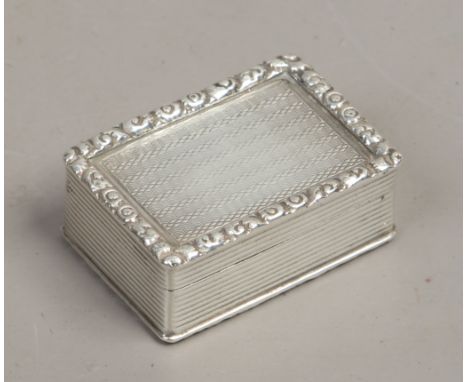 A silver snuff box reeded with engraved decoration cast floral borders, assayed London 1931, 30 grams.