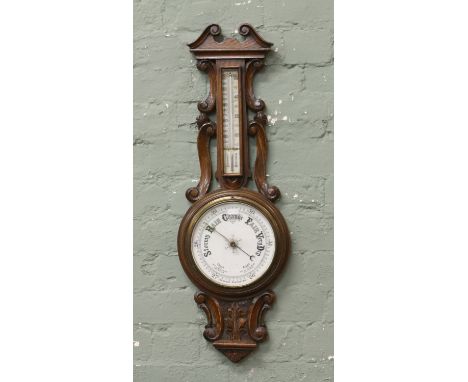 A George V carved oak wall barometer 