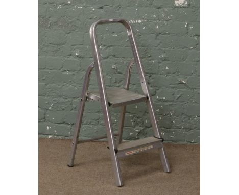 A small set of aluminium step ladders.