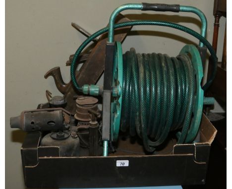 Two vintage blow lamps, storm lantern, Primus stove, block plain and a garden hose reel.