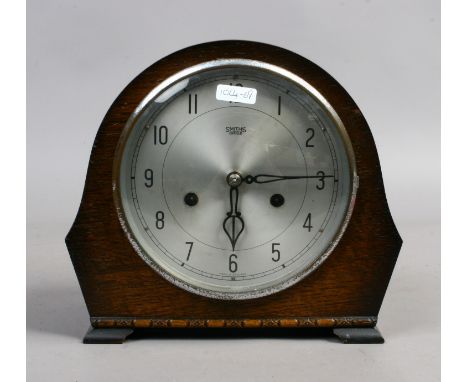 An oak cased Smith Enfield mantel clock with key and pendulum. 