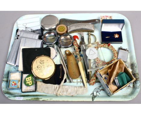 A tray of collectables including Strattons powder compact, Art Deco cigarette cases, Honer harmonica, driving medals , novelt