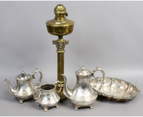 A brass corinthian column oil lamp, a silver plated three part teaset and a silver plated Lozenge shaped copper dish.