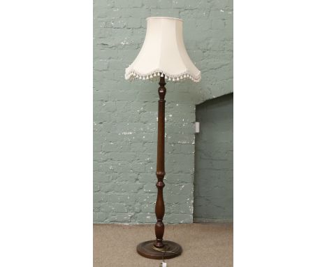 A mahogany standard lamp with reeded and turned base.