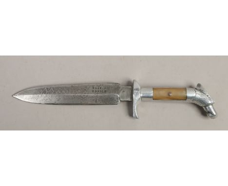 A hunting knife with stylized eagle grip having horn scales with etched blade stamped Mexico.