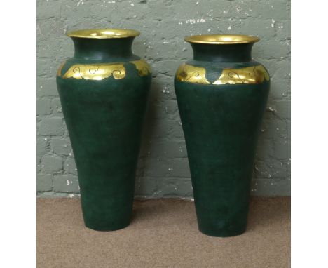 A pair of large ceramic vases with green and gilt decoration.