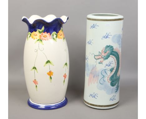 Two decorative ceramic stick stands one decorated with a serpent.