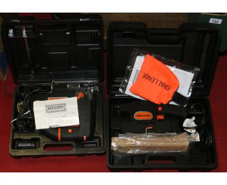 A cased Challenge 710w pendulum jigsaw, along with a cased Challenge 1/3-sheet sander kit.