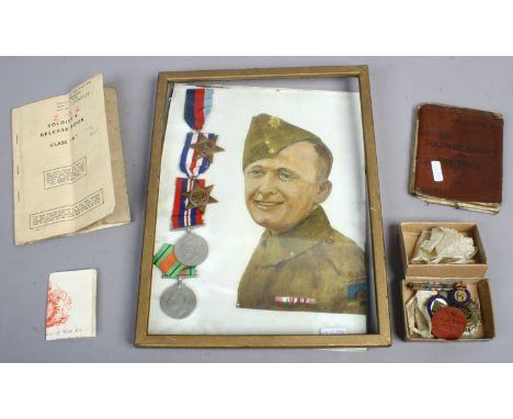 A framed group of four World War II medals, 1939-45 star, France & Germany star with a portrait of a soldier and relative eph