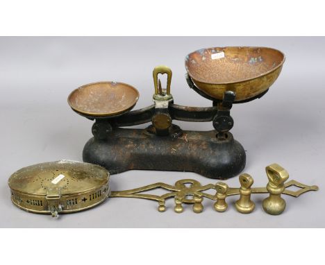 A set of cast iron kitchen scales and weights and a brass chestnut roaster.