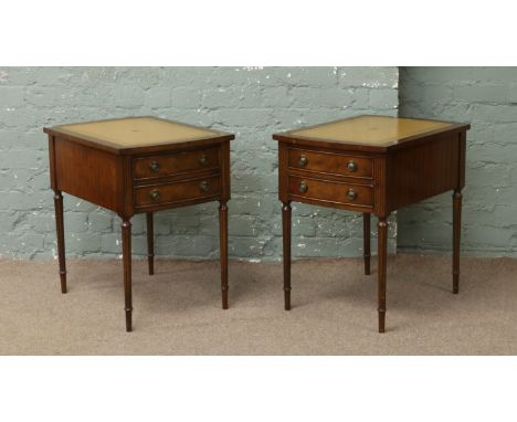 A pair of mahogany two drawer lamp tables rasied on tapering reeded supports.