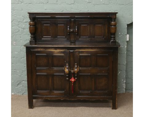 A vintage Ercol court cupboard.