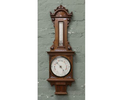 A Victorian extensively carved mahogany aneroid barometer
