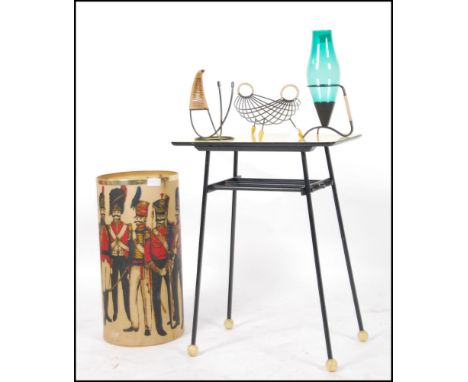 A 1950's yellow formica on metal pin leg side table. The table with yellow finial feet together with  a wirework bottle stand