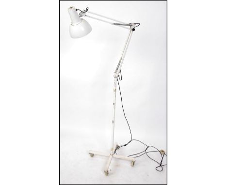 A freestanding Herbert Terry Industrial 1970's floor standing anglepoise lamp on trolley. The angled arm with when pendant sh