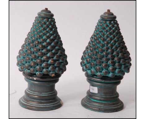 An unusual 1970's pair of ceramic lights of tapering two part form having ball finish over circular plinths. 35cm high
