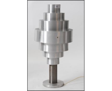 A 1960's chrome table lamp. The circular chrome banded shade of graduating modular form raised over a plinth base. 54cm high.