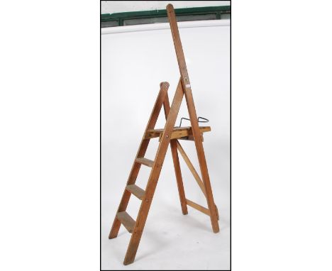An early 20th century Air Ministry pine step latter. The good pine ladder with crows foot markings opening to slatted top wit