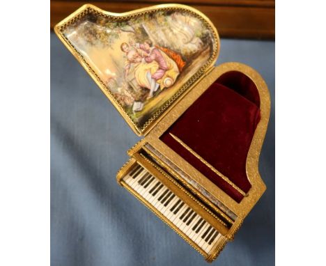 An enamel and gilt metal piano musical box, decorated with figures in landscape and cherubs