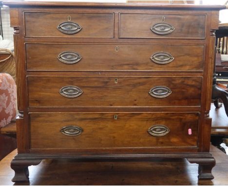 A mahogany chest of drawers, fitted with two short over three long drawers, with reeded column decoration, raised on ogee bra