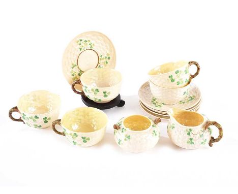  THIRTEEN PIECE SECOND PERIOD BELLEEK TEA SET WITH A SHAMROCK DESIGN.COMPRISING SIX SAUCERS, FIVE CUPS, CREAM AND SUGAR.CUP H