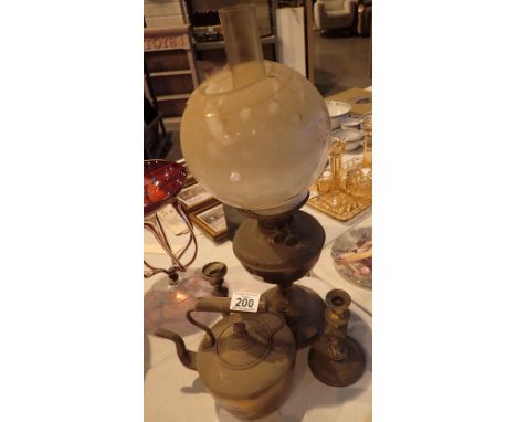 Antique brass oil lamp with glass shade brass kettle and two brass candlesticks 