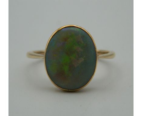 An unmarked gold and opal ring. Ring size P.