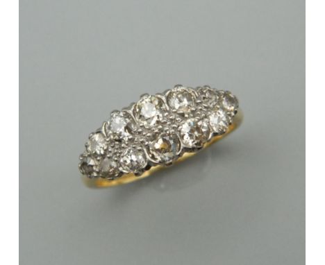 An 18 ct gold and platinum twelve stone diamond ring. Ring size P/Q.