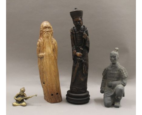 A Chinese carved wooden statue of a sage, a resin figure of a Chinese official, a model of a terracotta warrior and a brass f