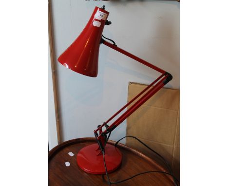 A red anglepoise lamp